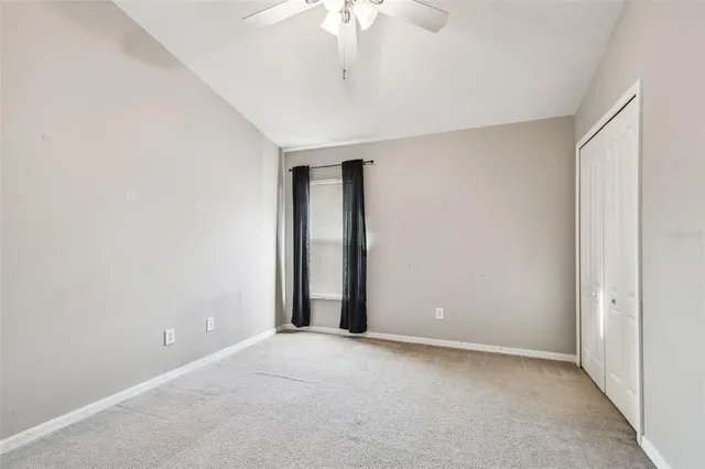 an empty room with a empty space and a ceiling fan