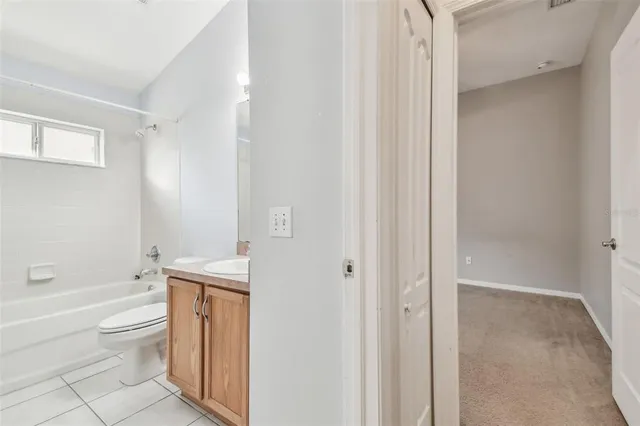 a bathroom with a toilet a sink and bathtub