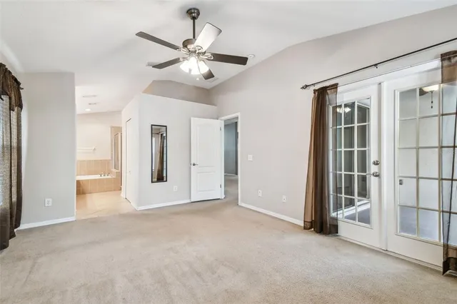 an empty room with closet and windows