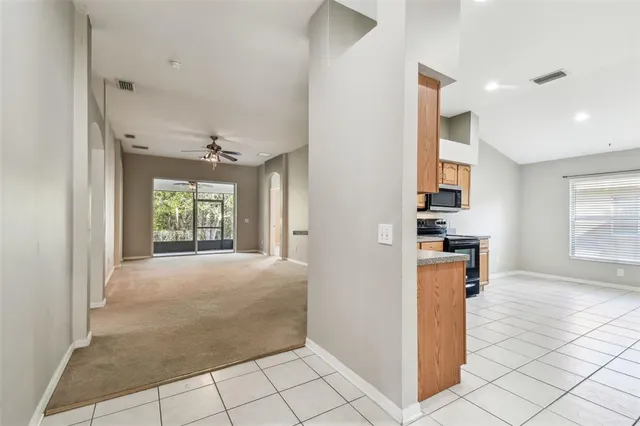 a view of livingroom with hardwood floor and a kitchen