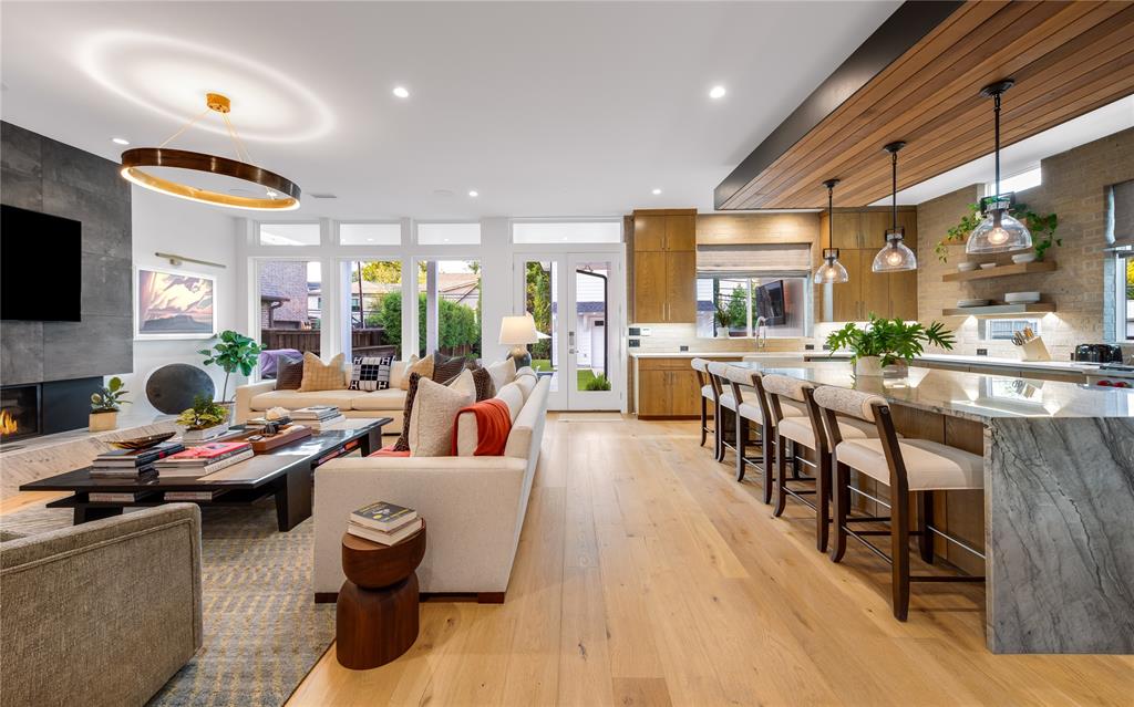 5531 Goodwin Avenue Dallas, TX 75206 - Photo 11 of 39 Living area with light wood-style flooring, a tiled fireplace, plenty of natural light, and recessed lighting