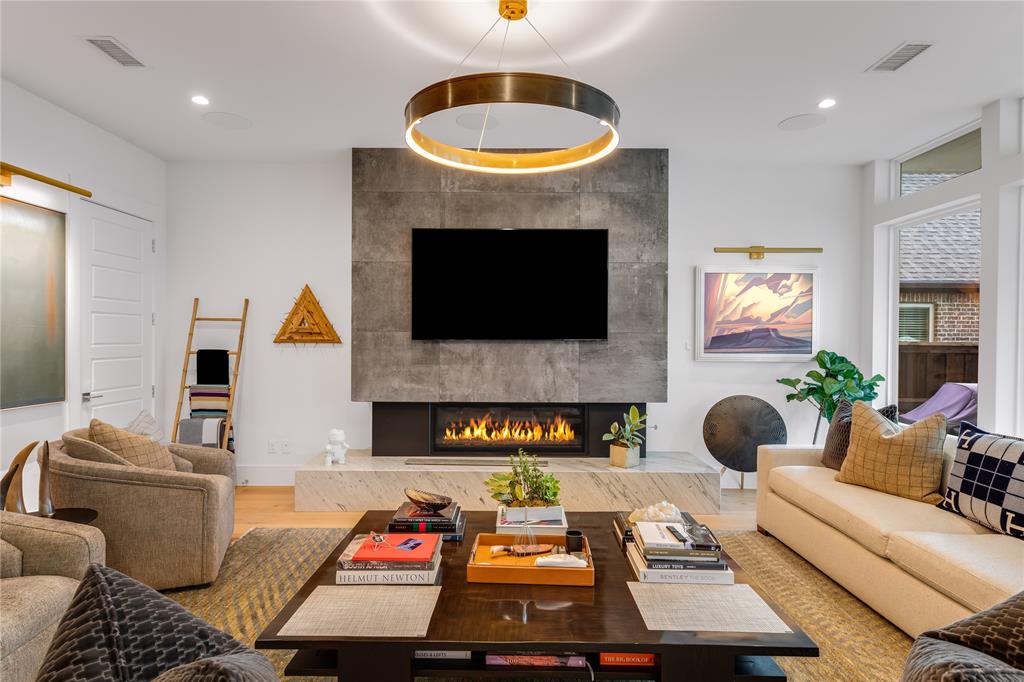 5531 Goodwin Avenue Dallas, TX 75206 - Photo 12 of 39 Living room with light wood finished floors, recessed lighting, and a premium fireplace