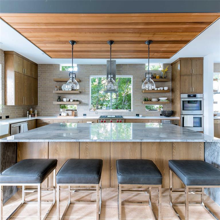 5531 Goodwin Avenue Dallas, TX 75206 - Photo 15 of 39 Kitchen featuring open shelves, wood finish cabinets, a kitchen bar, hanging light fixtures, and wood ceiling