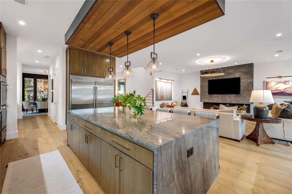 5531 Goodwin Avenue Dallas, TX 75206 - Photo 39 of 39 Kitchen with dark stone counters, open floor plan, a large island, and modern cabinets