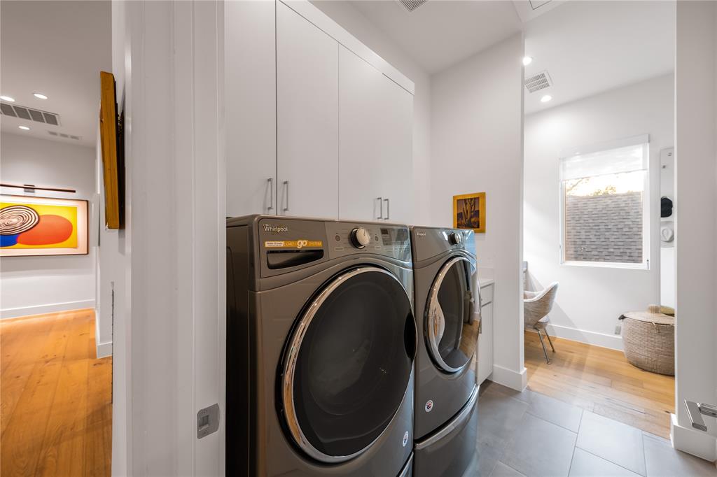 5531 Goodwin Avenue Dallas, TX 75206 - Photo 30 of 39 Laundry area featuring recessed lighting, cabinet space, washer and dryer, and light wood-type flooring
