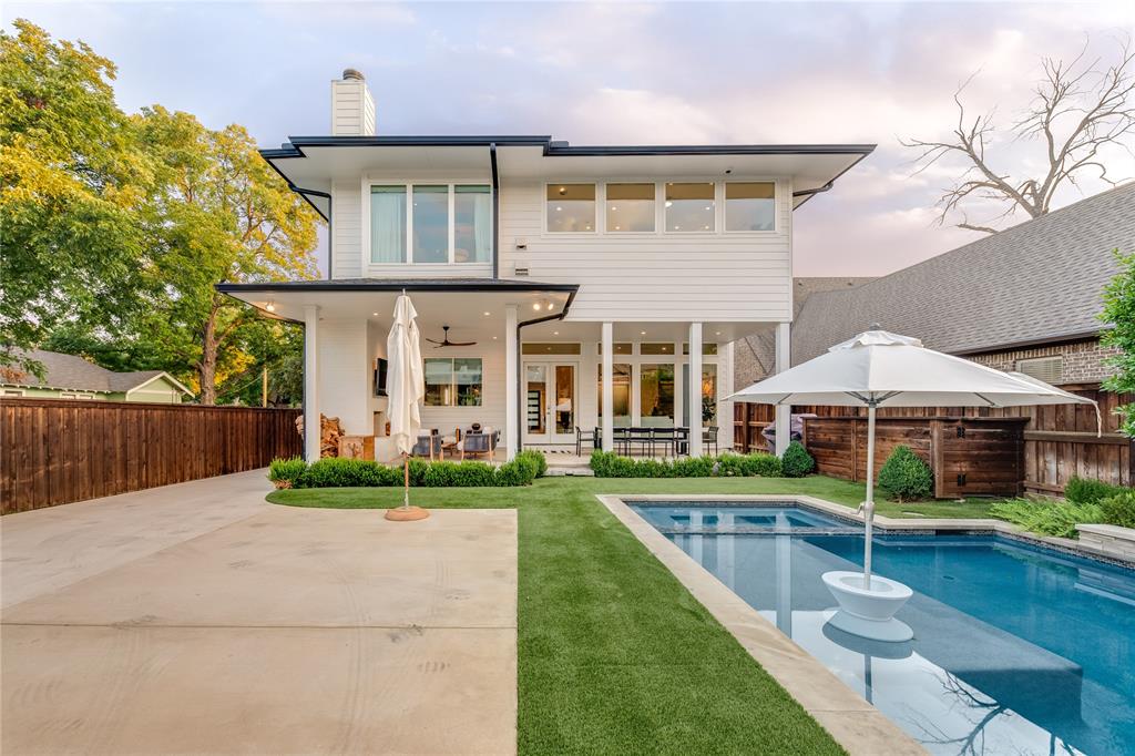 5531 Goodwin Avenue Dallas, TX 75206 - Photo 4 of 39 Rear view of property featuring a patio, a fenced backyard, a chimney, and a pool with connected hot tub