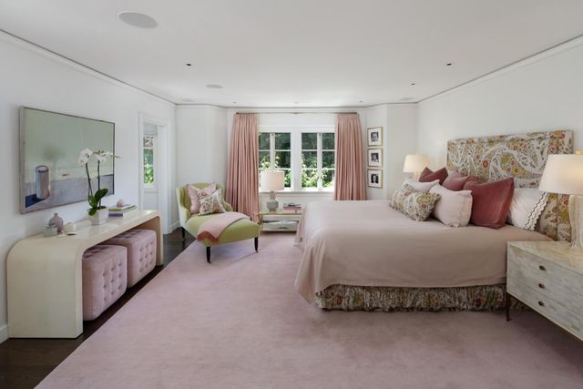 a spacious bedroom with a bed and a couch