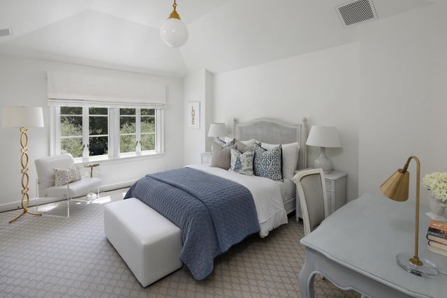 a spacious bedroom with two beds and a couch