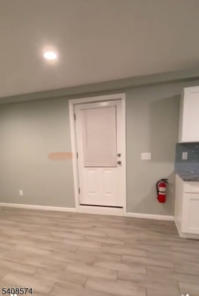 37 Edison Street Bloomfield, NJ 07003 - Photo 8 of 11 a view of an empty room with wooden floor and cabinets