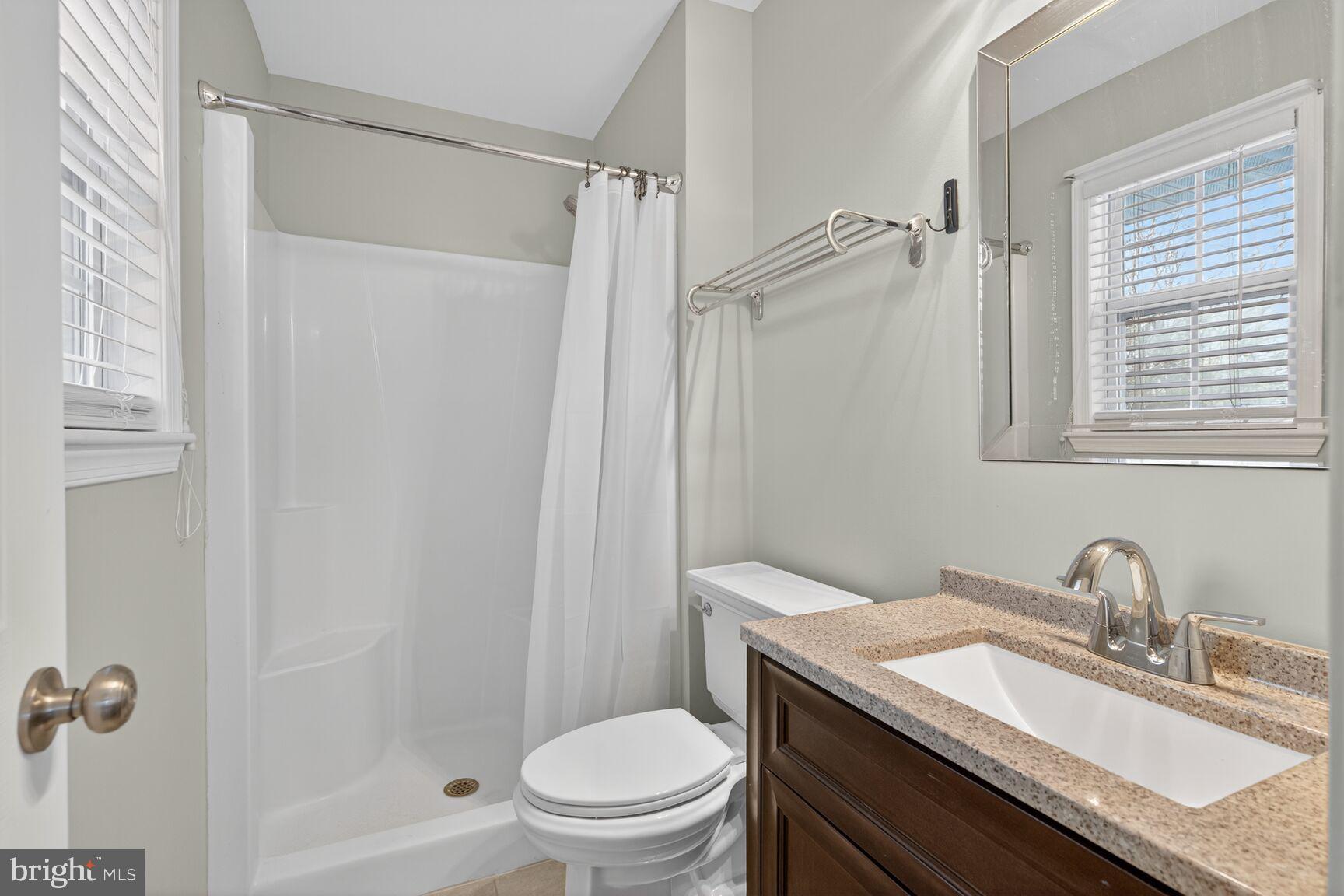 599 Widewater Road Stafford, VA 22554 - Photo 13 of 27 a bathroom with a granite countertop sink toilet and shower