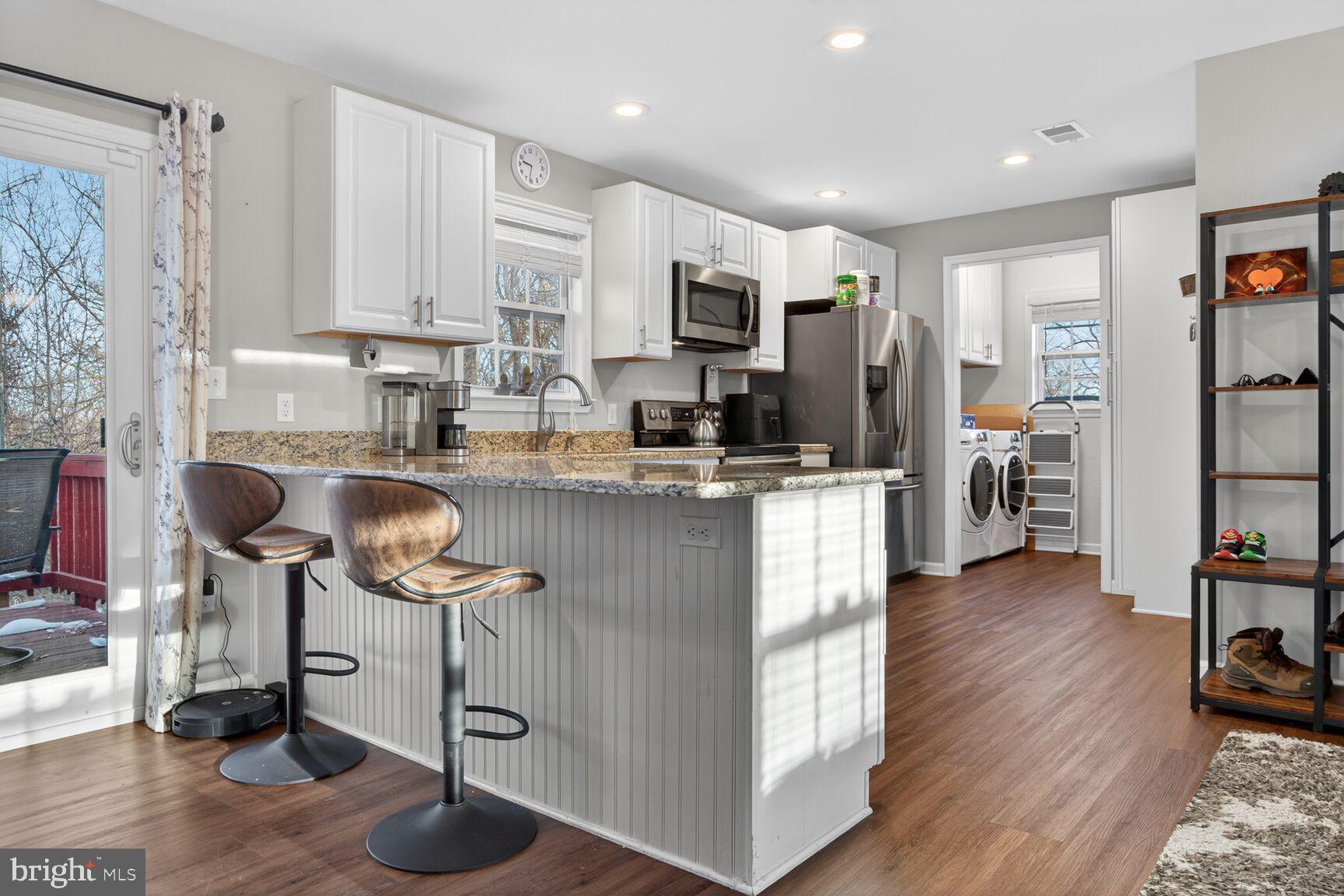599 Widewater Road Stafford, VA 22554 - Photo 15 of 27 a kitchen with stainless steel appliances granite countertop a refrigerator oven a sink a stove and island with wooden floor