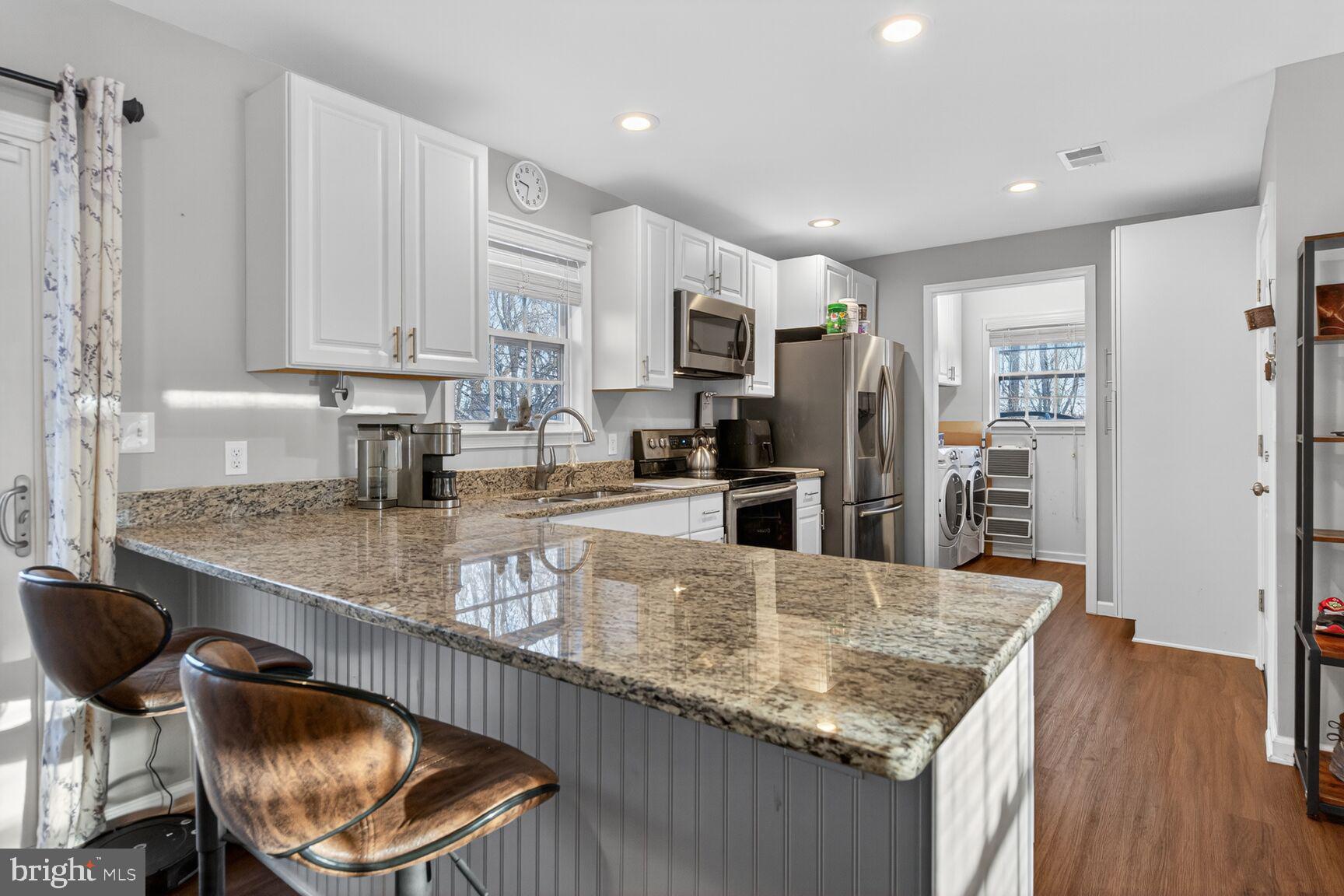 599 Widewater Road Stafford, VA 22554 - Photo 16 of 27 a kitchen with stainless steel appliances granite countertop a sink refrigerator and cabinets