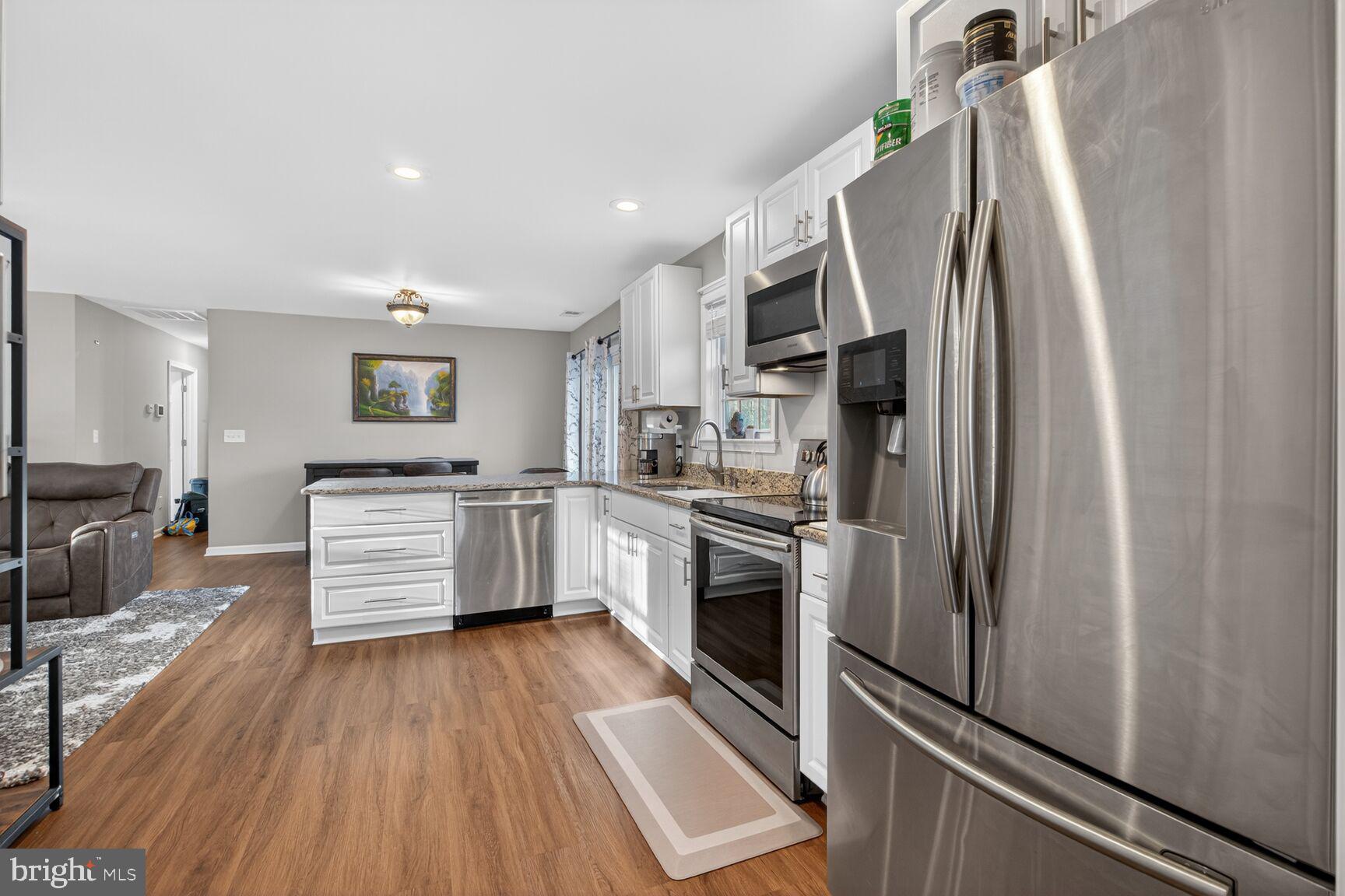 599 Widewater Road Stafford, VA 22554 - Photo 17 of 27 a kitchen with stainless steel appliances a refrigerator and a stove top oven