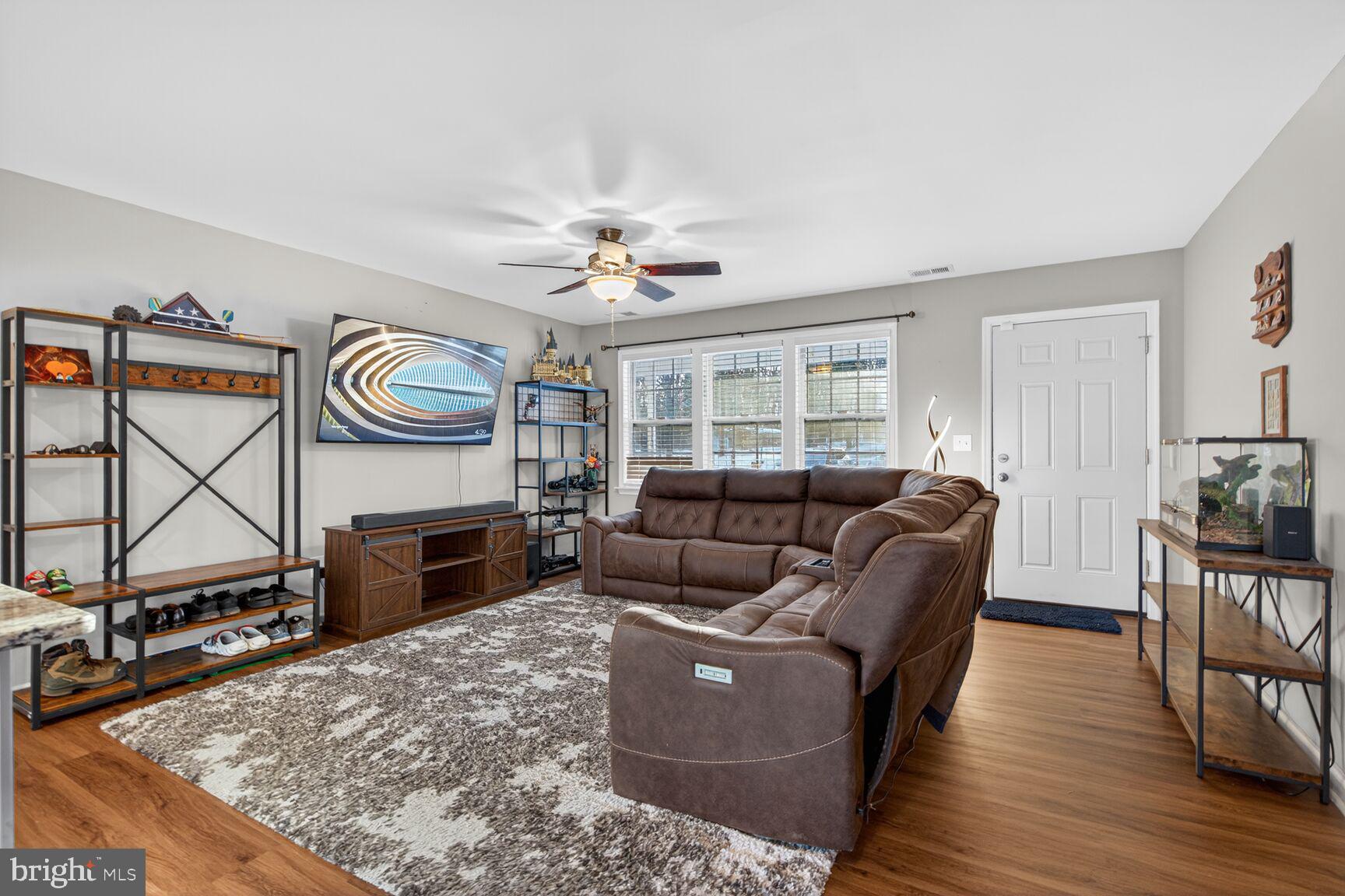 599 Widewater Road Stafford, VA 22554 - Photo 19 of 27 a living room with furniture a flat screen tv and a fireplace