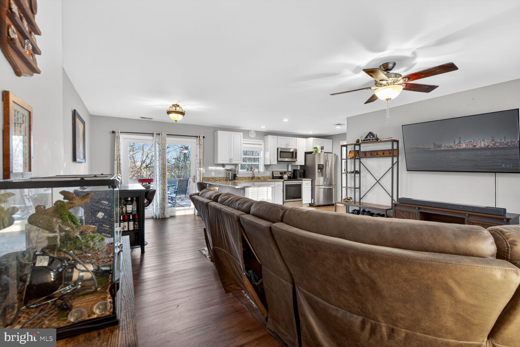 599 Widewater Road Stafford, VA 22554 - Photo 23 of 27 a living room with furniture and a chandelier