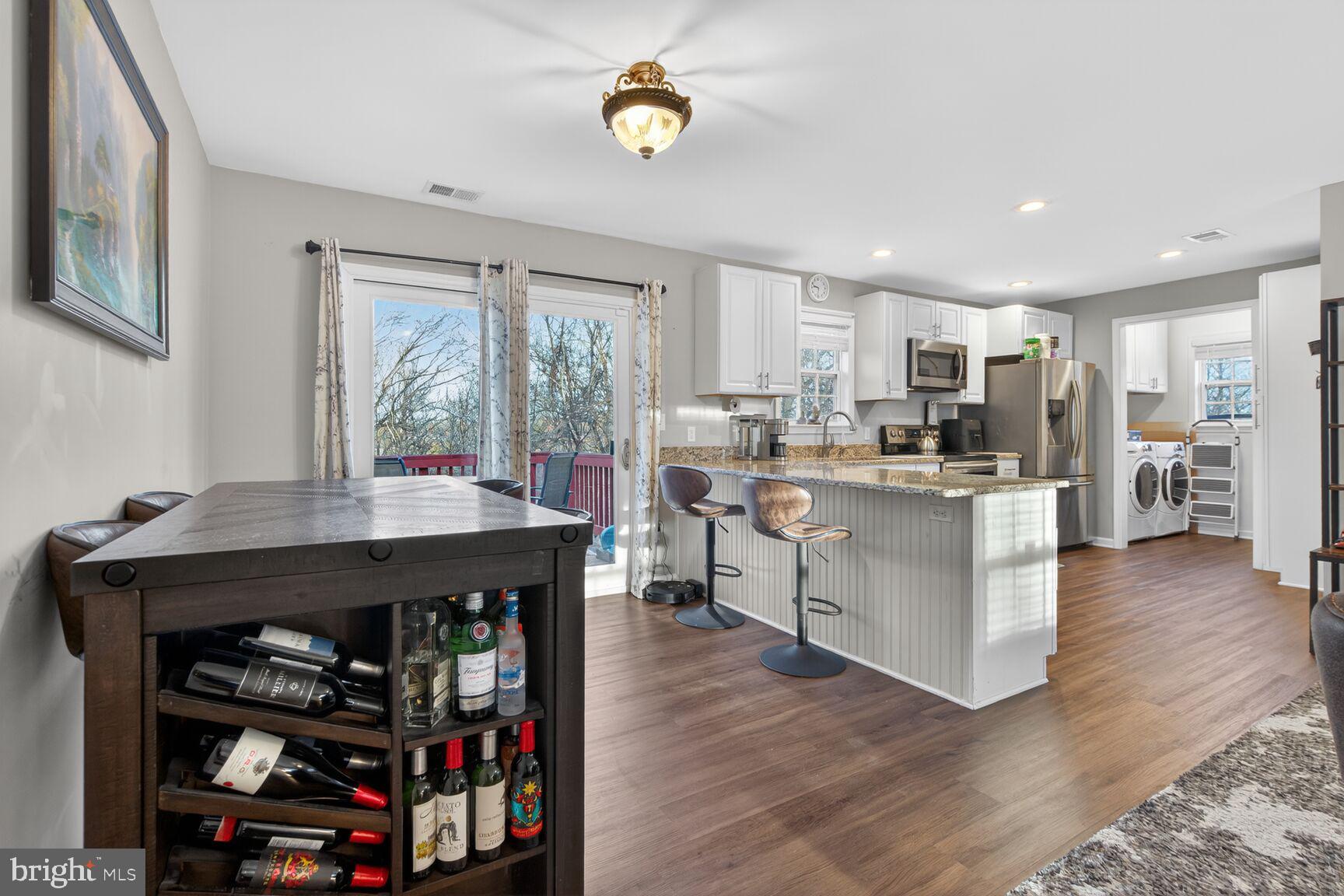599 Widewater Road Stafford, VA 22554 - Photo 24 of 27 a open kitchen with stainless steel appliances granite countertop a stove and a refrigerator