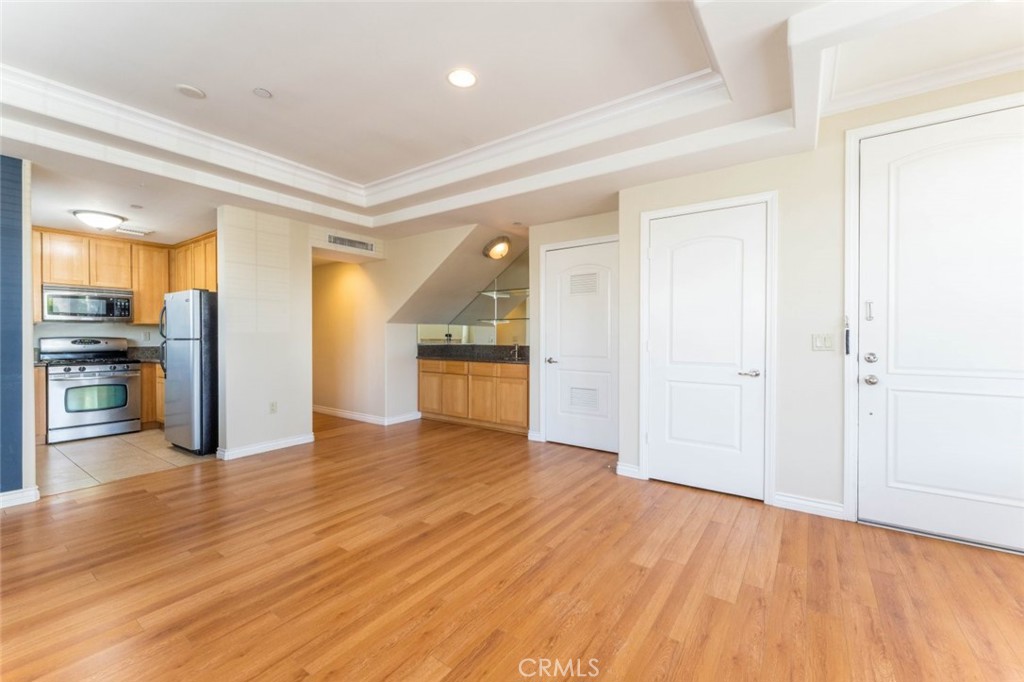 511 East Harvard Road, Unit 101 Burbank, CA 91501 - Photo 5 of 29 wooden floor in an empty room and a window