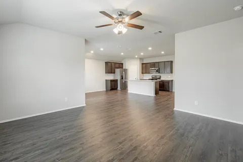 a view of kitchen with stove and wooden floor