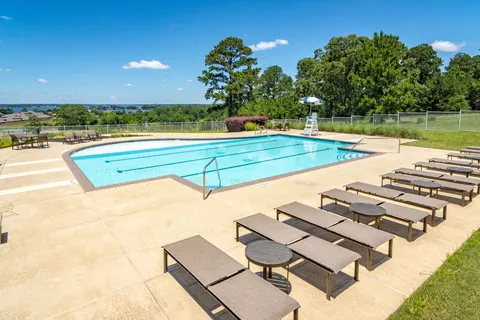 a view of a swimming pool with lounge chairs