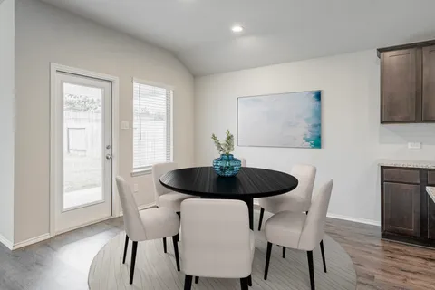 a view of a dining room with furniture and wooden floor