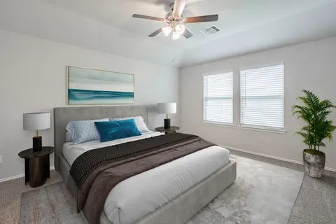 a bedroom with bed and a potted plant
