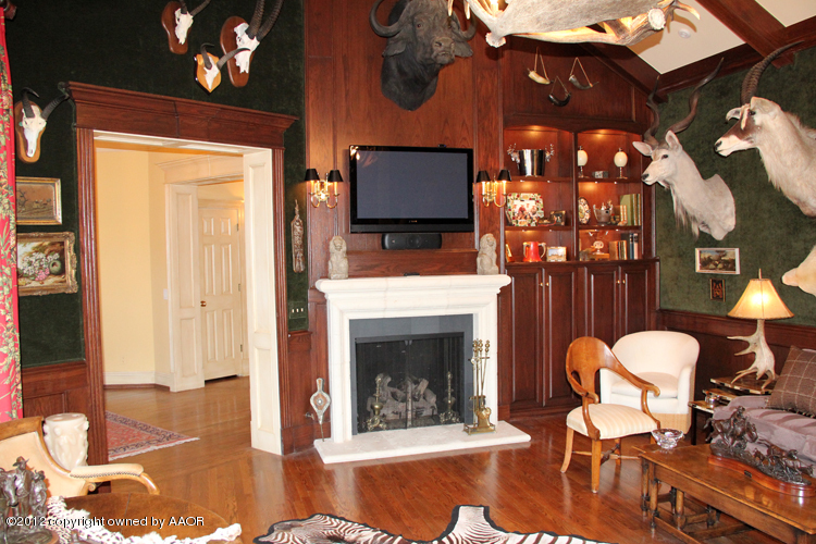 8 Edgewater Drive Amarillo, TX 79106 - Photo 12 of 41 a living room with furniture a dining table and a fireplace