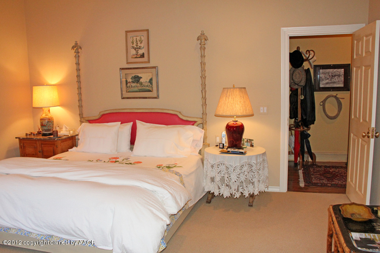 8 Edgewater Drive Amarillo, TX 79106 - Photo 14 of 41 a bedroom with a bed and a lamp