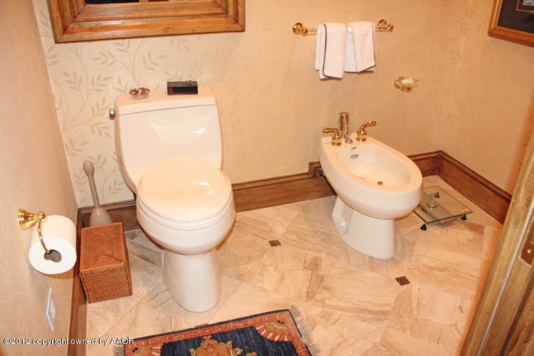 8 Edgewater Drive Amarillo, TX 79106 - Photo 22 of 41 a bathroom with a toilet mirror and vanity