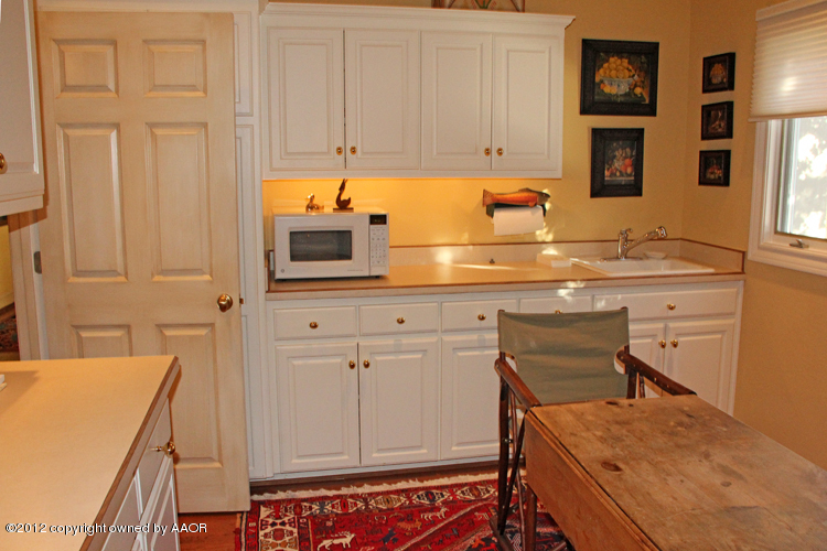 8 Edgewater Drive Amarillo, TX 79106 - Photo 28 of 41 a kitchen with a sink and cabinets