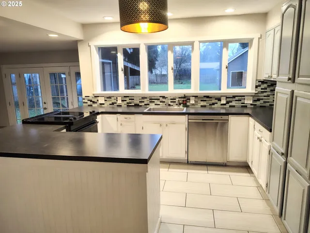 a kitchen with a sink and a stove top oven