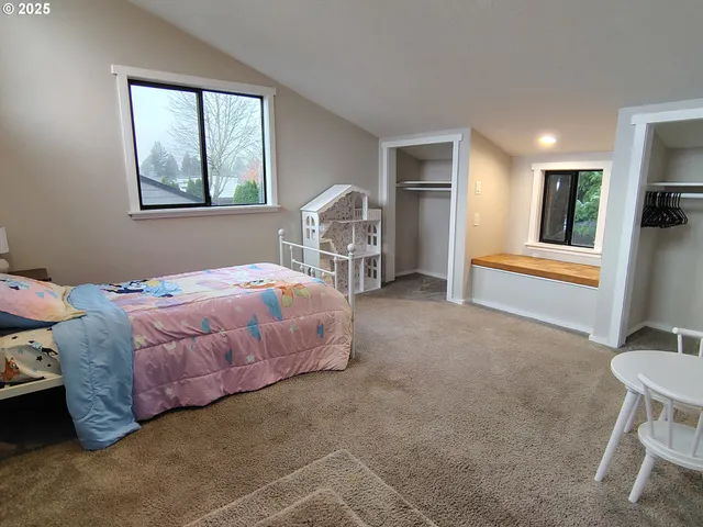 a bedroom with a bed and a chair