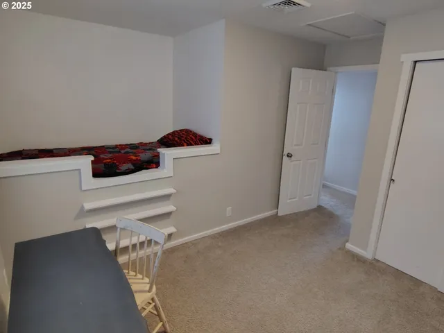 a view of an empty room with cabinet