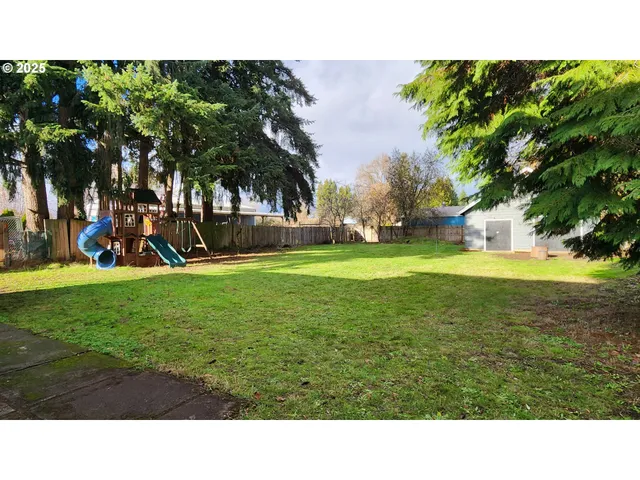 a backyard of a house with table and chairs