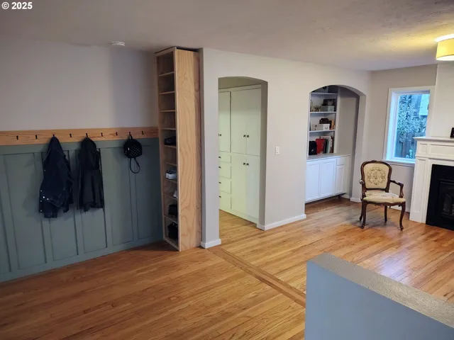 a view of a livingroom with furniture and closet with wooden floor