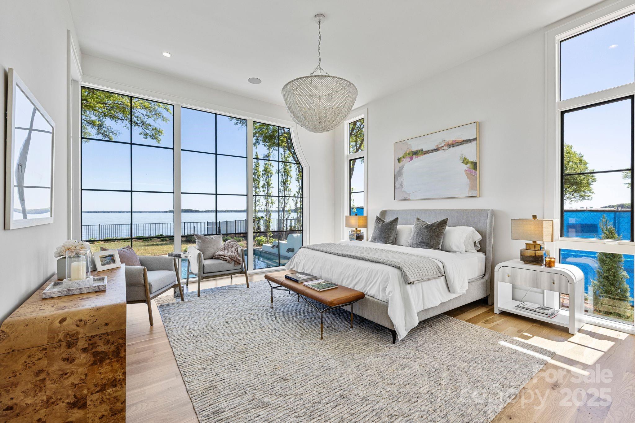 8397 Ranger Island Marina Road Denver, NC 28037 - Photo 22 of 48 a spacious bedroom with a bed a couch and large window