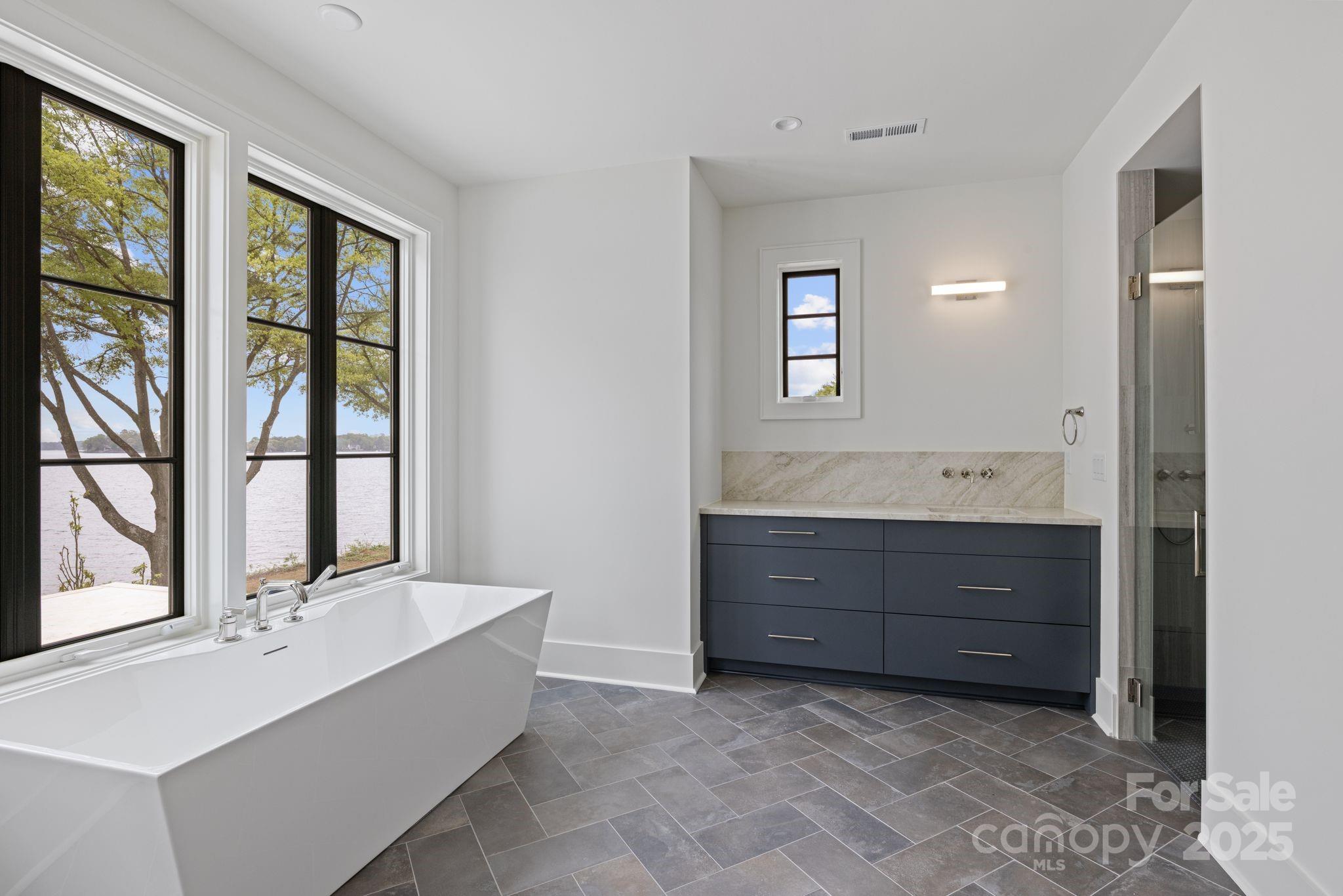 8397 Ranger Island Marina Road Denver, NC 28037 - Photo 33 of 48 a bathroom with a sink double vanity and a tub