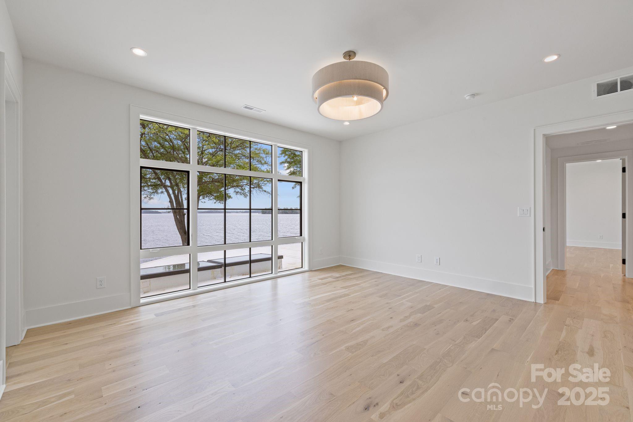 8397 Ranger Island Marina Road Denver, NC 28037 - Photo 35 of 48 an empty room with wooden floor and windows