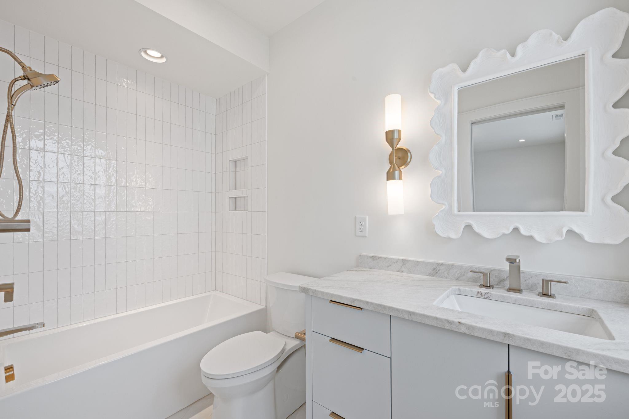 8397 Ranger Island Marina Road Denver, NC 28037 - Photo 36 of 48 a bathroom with a sink a toilet a mirror a vanity and shower