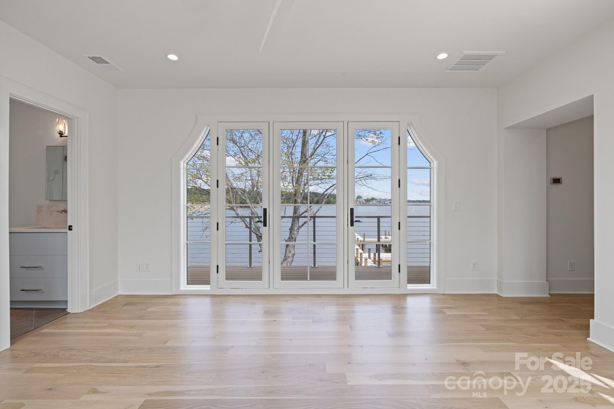 8397 Ranger Island Marina Road Denver, NC 28037 - Photo 37 of 48 wooden floor in an empty room with a window