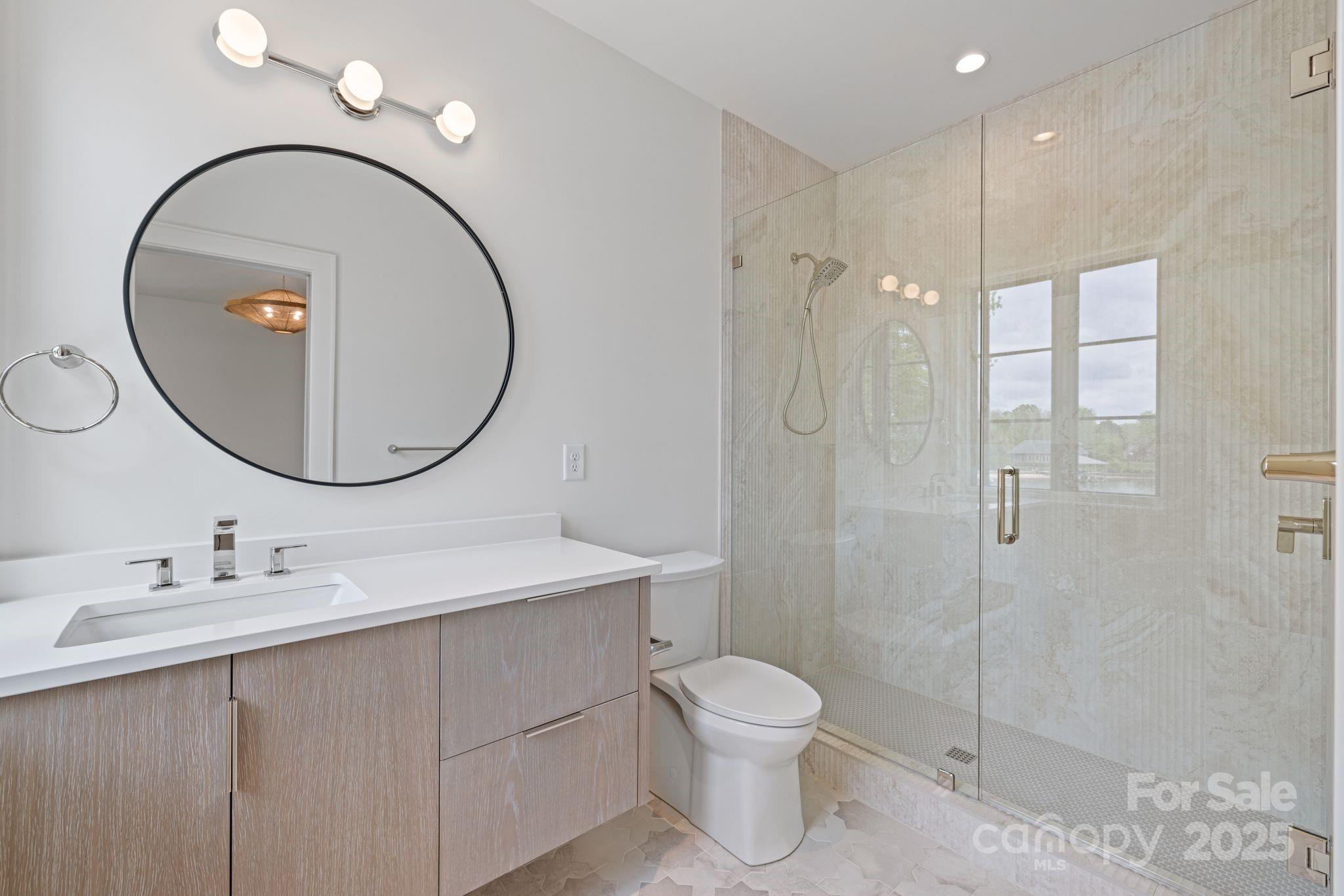 8397 Ranger Island Marina Road Denver, NC 28037 - Photo 38 of 48 a bathroom with a sink a toilet and a mirror