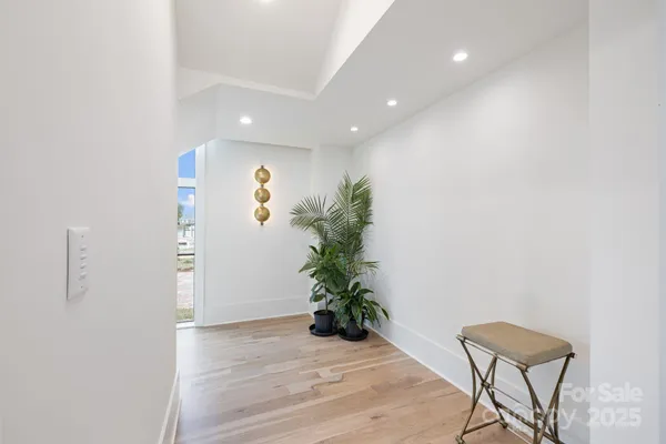 an empty room with a fireplace and wooden floor