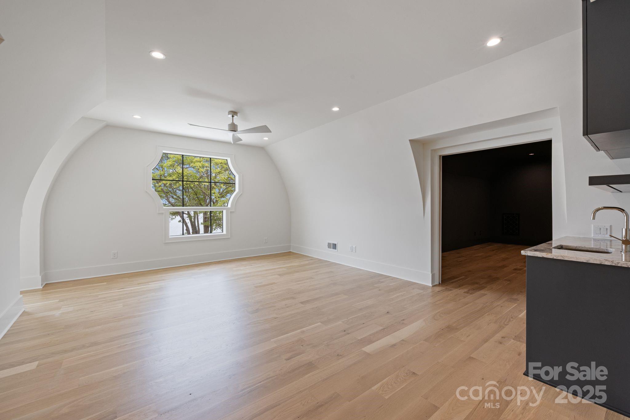 8397 Ranger Island Marina Road Denver, NC 28037 - Photo 44 of 48 an empty room with a fireplace and wooden floor
