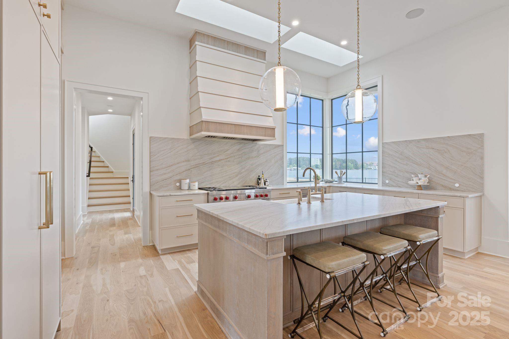8397 Ranger Island Marina Road Denver, NC 28037 - Photo 5 of 48 a kitchen with kitchen island a stove a table and chairs in it