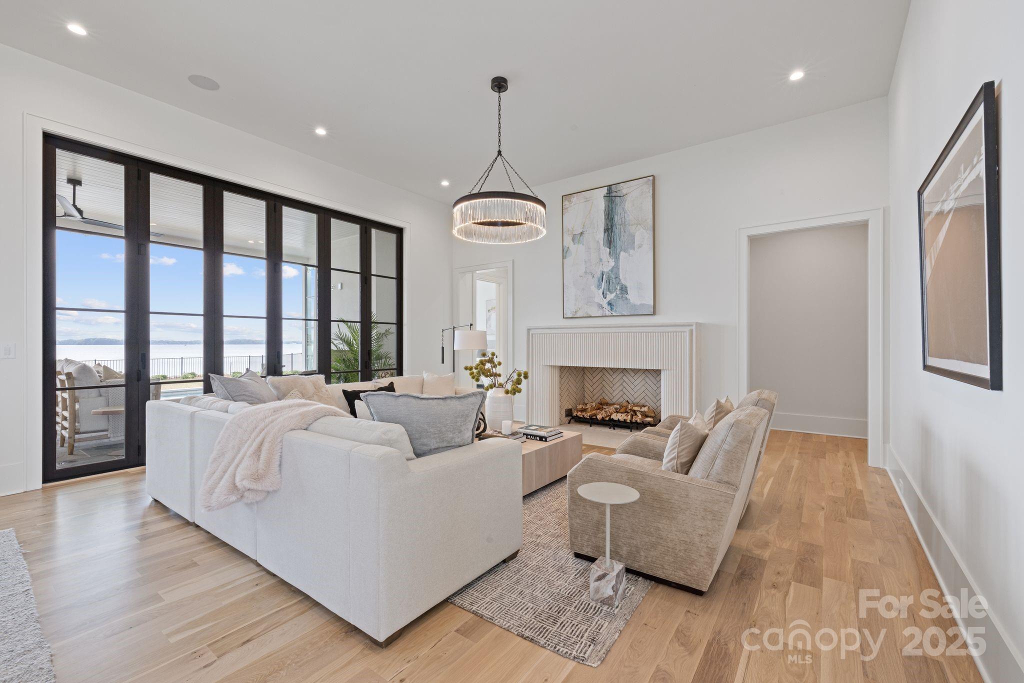 8397 Ranger Island Marina Road Denver, NC 28037 - Photo 10 of 48 a living room with furniture and a chandelier