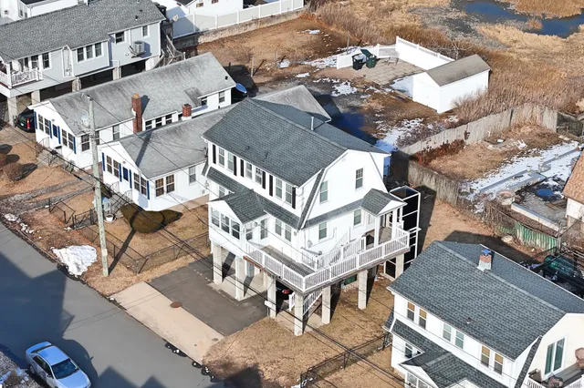 an aerial view of a house with roof deck outdoor seating and city view