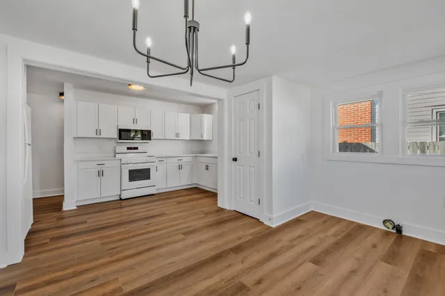 a view of a room with wooden floor and a window
