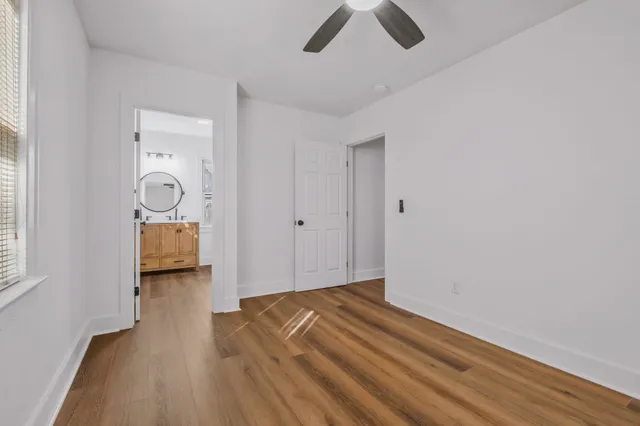 a bathroom with a toilet a sink and a mirror