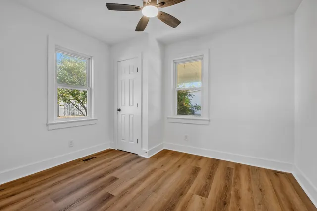 a view of a room with wooden floor