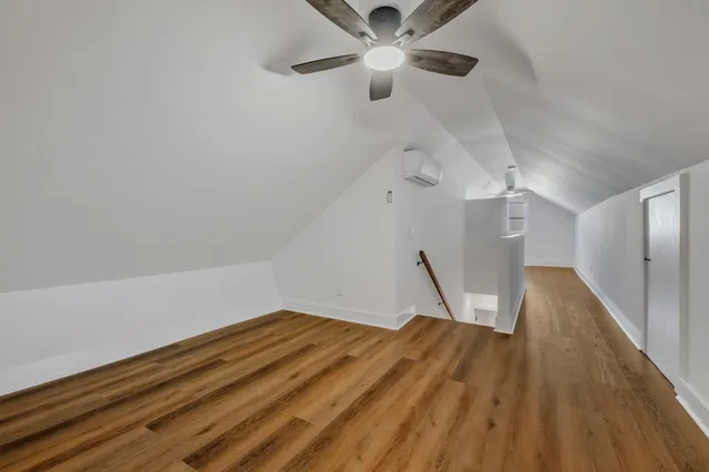 a view of a room with wooden floor ceiling fan