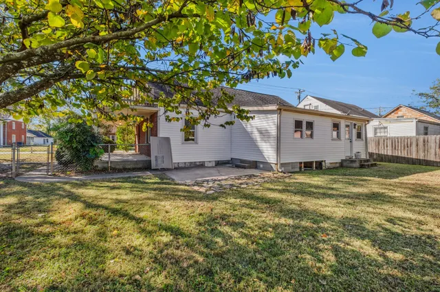 a view of a porch with wooden floor and a yard